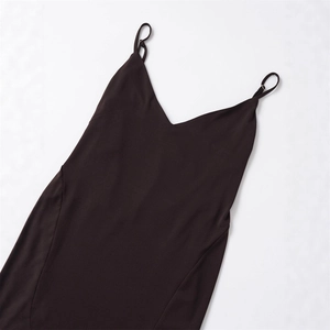 Detail of adjustable metal buckles on thin spaghetti straps of a slim-fit V-neck dress