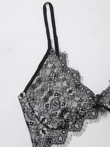 Close-up of elegant black floral lace lingerie with delicate eyelash trim and adjustable straps