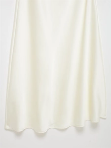 Detailed view of the glossy satin fabric and elegant drape of this white evening dress