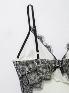 Detailed view of white satin camisole with exquisite black floral eyelash lace trim