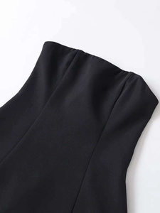 Close-up of black tube top dress showing tailored seams and premium woven fabric