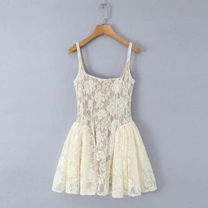 Close-up of intricate floral lace crochet pattern and fabric texture of the white sundress