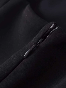 Close-up of a seamless invisible zipper on a black sleeveless midi dress for women