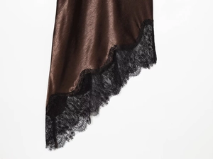 Detail of dark coffee satin dress featuring intricate black eyelash lace hem and silky texture