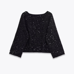 Detail shot of the black round neck jacket with shimmering all-over sequins texture