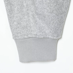 Detail of grey fleece jacket showing ribbed cuffs and high-quality stitching on sleeve