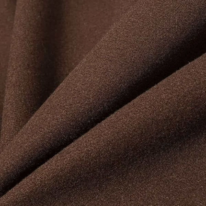 Close-up of deep brown wool blend fabric texture with elegant draping folds