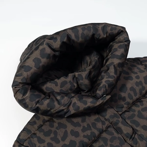 Detailaufnahme des Kragens einer Pufferjacke mit dunklem Leopardenmuster und Seidenglanz