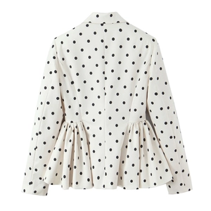 Rear view of white peplum blazer with black polka dots and pleated hem detail