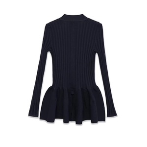 Detail of navy blue ribbed knit dress featuring peplum hem and slim fit design