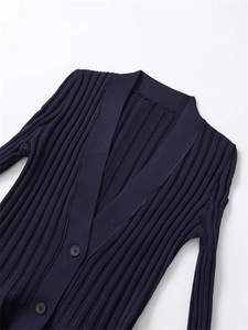 Close-up of dark blue ribbed knit dress with V-neckline and elegant dark buttons