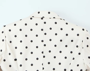 Close-up of the high-quality stitching and polka dot pattern on the blazer back