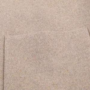 Detail shot of oatmeal blend high neck coat showing fabric texture and patch pocket design