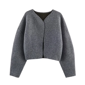 Detail showing the fuzzy wool texture and dark gray knit fabric of the cardigan