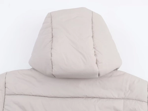 Close-up of beige hooded jacket showing detailed horizontal quilting and matte fabric