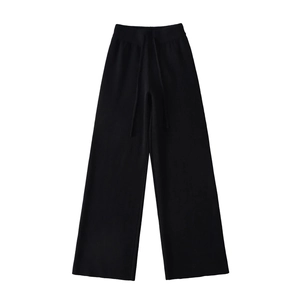 Detail of high waisted drawstring waistband on thick black wide leg knitted trousers