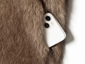 Detail of the side pocket on this faux fur vest, showing phone storage capability