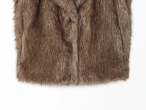 Detailed macro view of high-quality brown faux fur texture and fibers on the winter vest