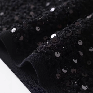 Women's crewneck jacket featuring black sequins on knitted fabric with ribbed trim