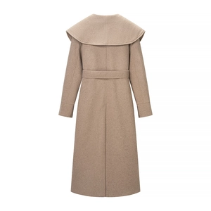Rear view of long camel wool coat with a large cape collar and waist belt detail