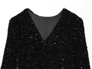 Detailed view of the V-neck design and high-quality black sequins on a slim fashion dress