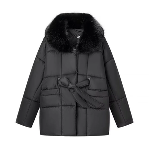 Detailed view of women's black quilted puffer coat featuring a lush faux fur collar