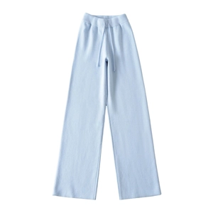Detail of high waist drawstring and ribbed waistband on light blue knit wide leg trousers