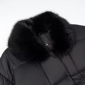 Close-up of black padded jacket detail featuring a plush faux fur collar and S size label