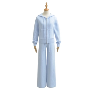 Detail of light blue knitted tracksuit featuring drawstring hoodie and wide leg pants