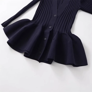 Navy blue V-neck ribbed knit cardigan featuring peplum hem and button-front design