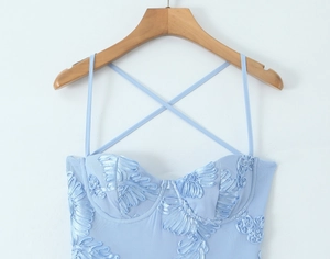 Close-up of light blue mesh bustier with 3D floral embroidery and thin straps