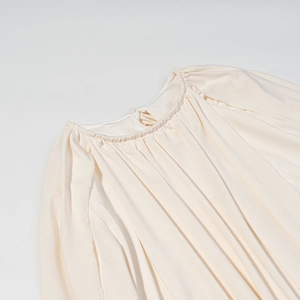 Robe cape beige élégante avec détail de décolleté plissé et fermeture à bouton au dos
