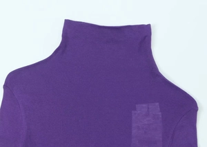 Detailed close-up of dark purple turtleneck top showing fabric texture and neckline