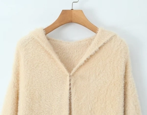 Close-up of the beige plush knit cardigan showing soft faux mink texture and button details