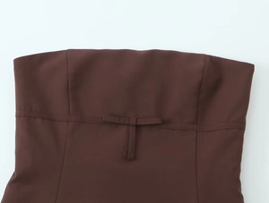 Detail of dark brown tube top showing neat stitching and elegant bow design