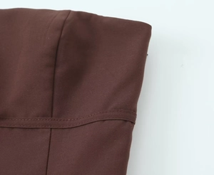 Detail of dark brown tank top featuring double-needle stitching and smooth cotton fabric