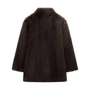 Detail view of the back of a plush dark brown faux fur jacket with thick texture