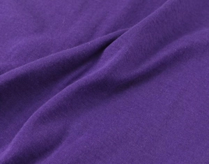 Detailed close-up showing the soft texture and weave of the purple knitted fabric top