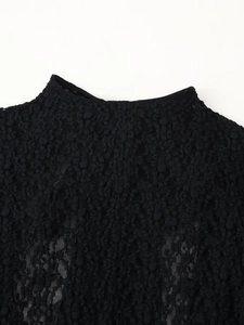 Close-up of black lace mesh bodysuit featuring high collar and intricate floral textures