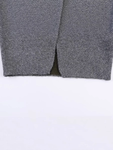 Close-up of thick grey wool knit texture with split detail on casual winter sweater