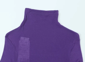 Detail shot of purple turtleneck top fabric featuring the official Supima cotton label
