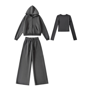 Detailed flat lay of charcoal grey 3-piece sports set with hoodie and wide-leg joggers