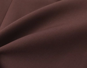 Macro detail of high-quality dark brown fabric showing tight uniform woven texture