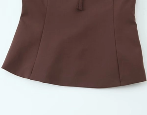 Close-up of the fine texture and neat stitching on this dark brown bow tube top's fabric