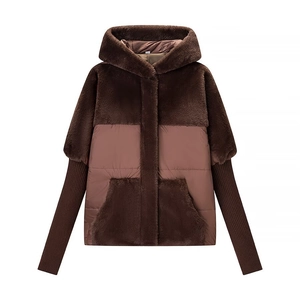 Detailed view of women's winter jacket with mixed faux fur and quilted fabric textures