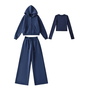 Detailed flat lay of navy blue three-piece tracksuit set with hoodie and wide-leg pants