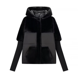 Detail of hooded jacket with faux fur panels and quilted texture in black