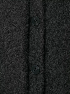 Macro detail of charcoal grey boucle fabric texture with soft fibers and black buttons