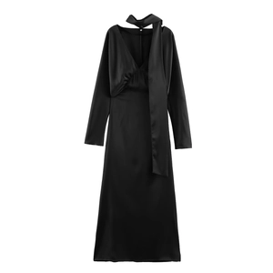 Detail of elegant black long-sleeve satin maxi dress with V-neckline and scarf tie detail