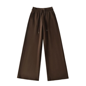 Detail view of deep brown wide-leg sweatpants featuring elastic waist and drawstring